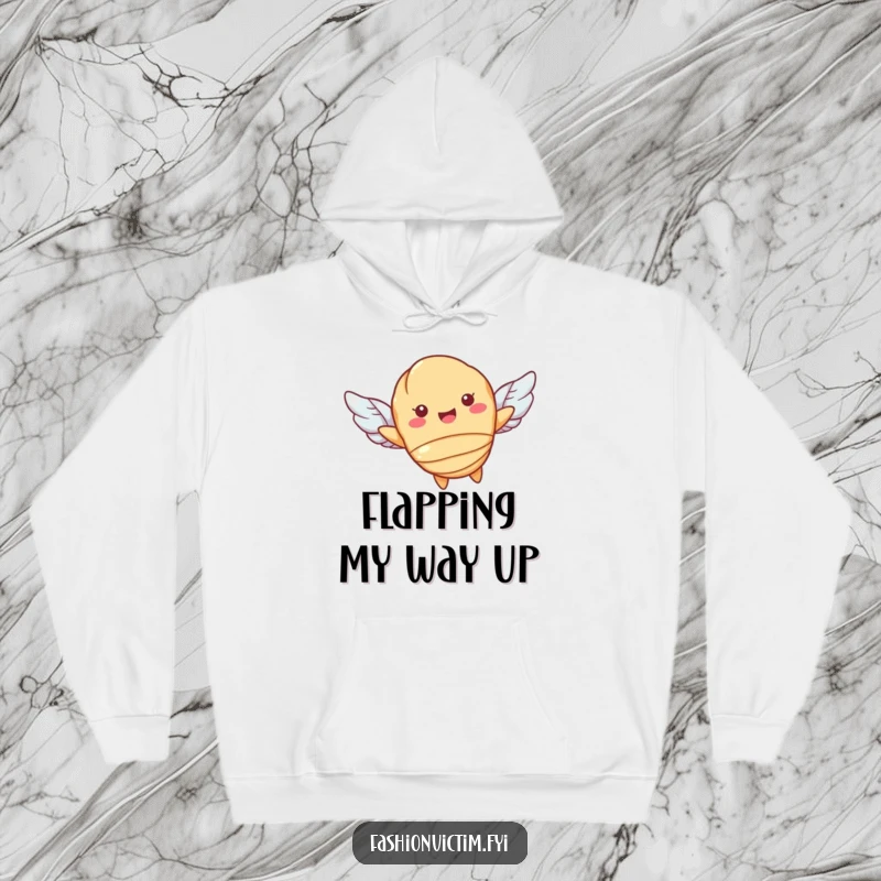 Funny hoodie with a cheerful croissant character flying on small wings, offering warmth and whimsical charm. Ideal for pastry enthusiasts.