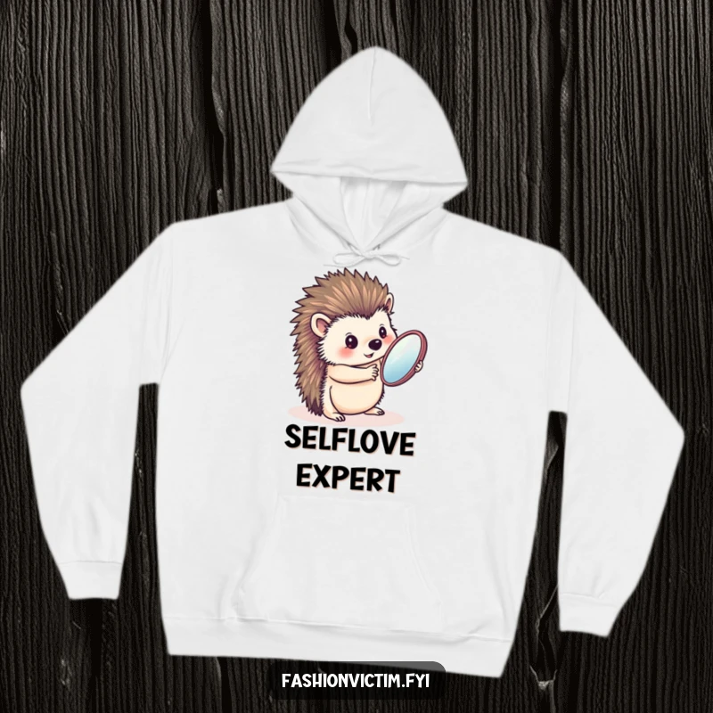 Funny hoodie showcasing a charming hedgehog admiring its reflection in a handheld mirror, offering warmth and a dose of humorous self-importance.
