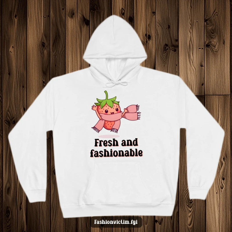 Funny hoodie with a tiny strawberry character waving a miniature stylish scarf. Cozy and humorous fashion.