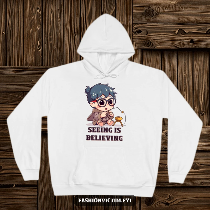 Funny hoodie depicting a character enthusiastically attempting to thread a tiny needle while wearing comically huge spectacles.