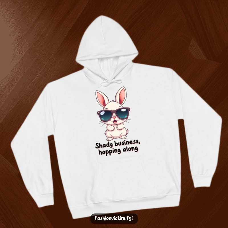 Funny hoodie with a small bunny attempting to wear gigantic sunglasses, looking gleeful and cool; comfortable attire for animal lovers.